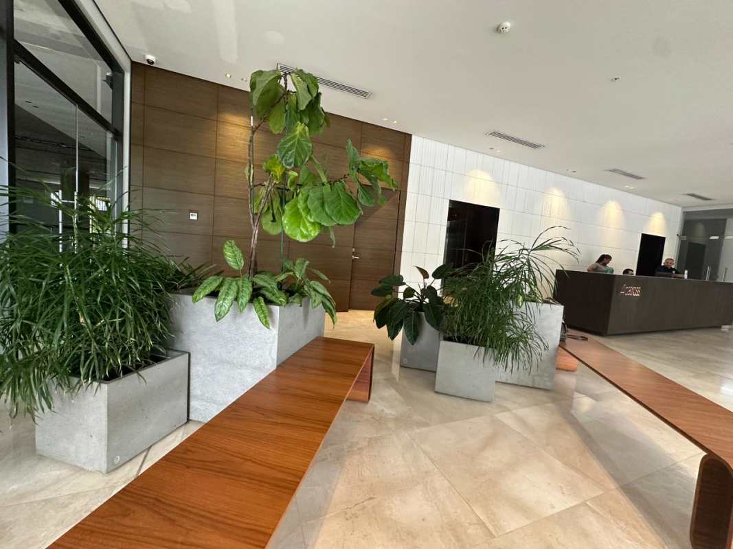 Modern luxury lobby with wood panels, marble accents and green plants at PH Albatross Santa María