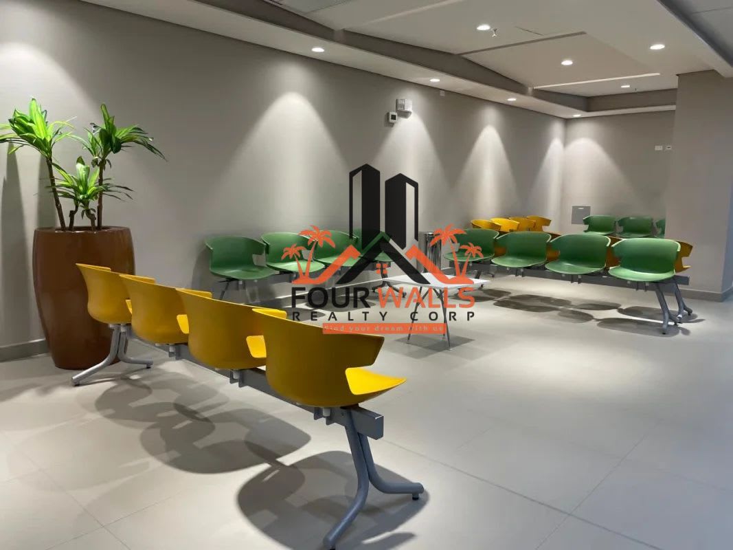 Modern lobby with yellow seating, plants, spot lighting Town Center Costa del Este Panama City