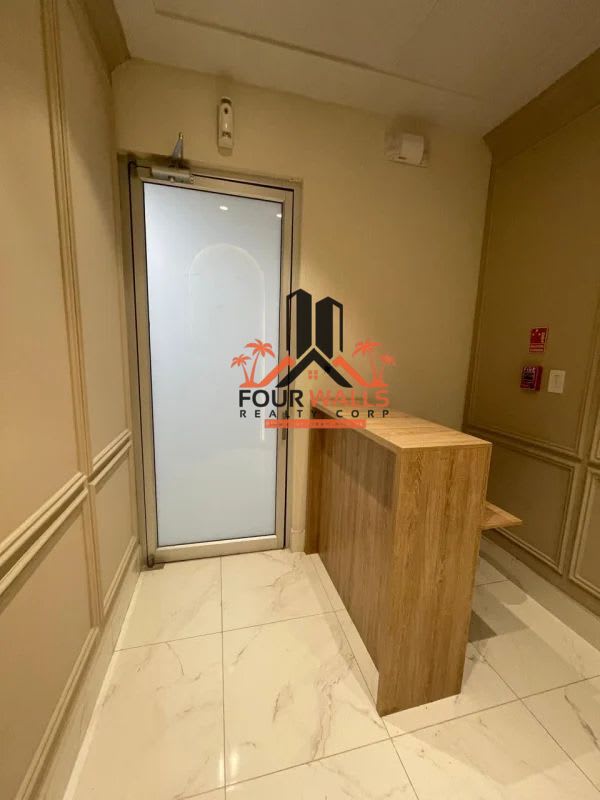 Reception entrance with frosted doors, wood desk, tiled flooring Town Center Panama