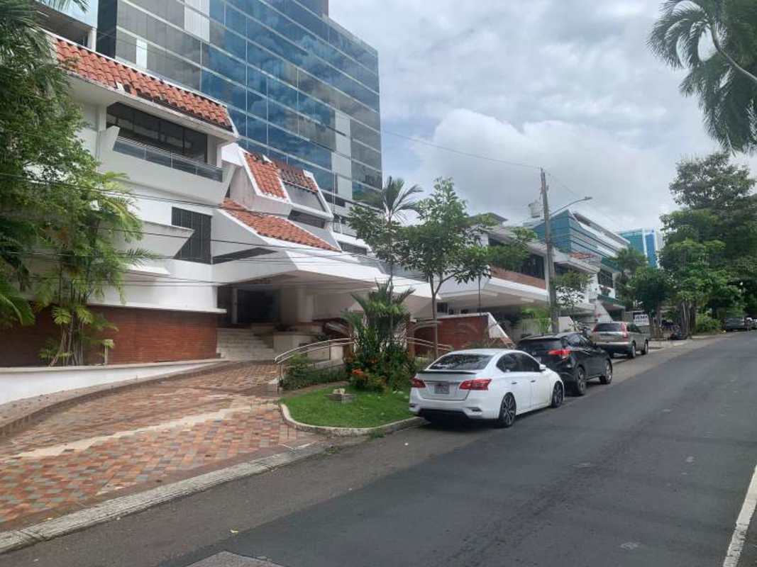 Spacious living room with marble floors, large windows overlooking Panama City skyline in Obarrio penthouse