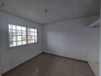 Empty tiled room with large window and security bars in house for sale Panama Oeste