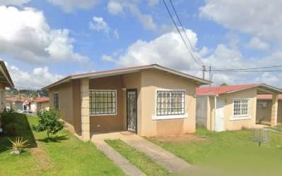 Side view of single-story affordable home with fenced yard space in La Chorrera Panama