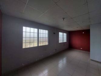Bedroom space with tiled floor and window bars in affordable home La Chorrera