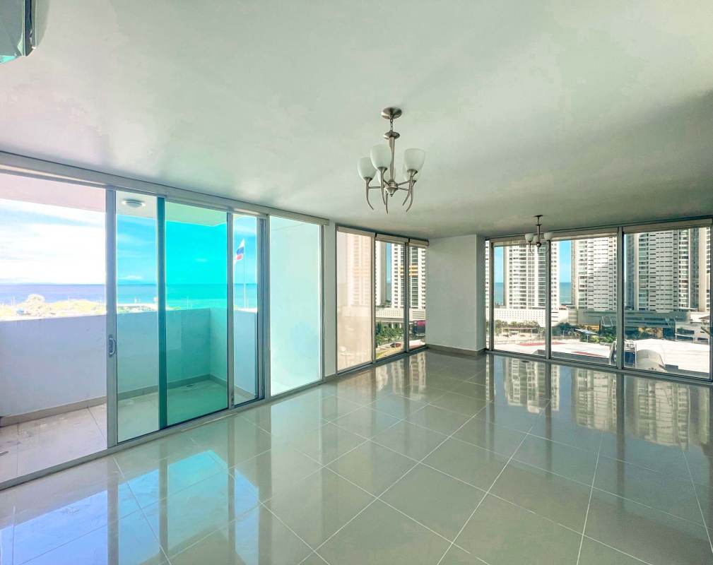 Living and dining room with floor-to-ceiling windows and ocean views in PH Privé San Francisco Panama