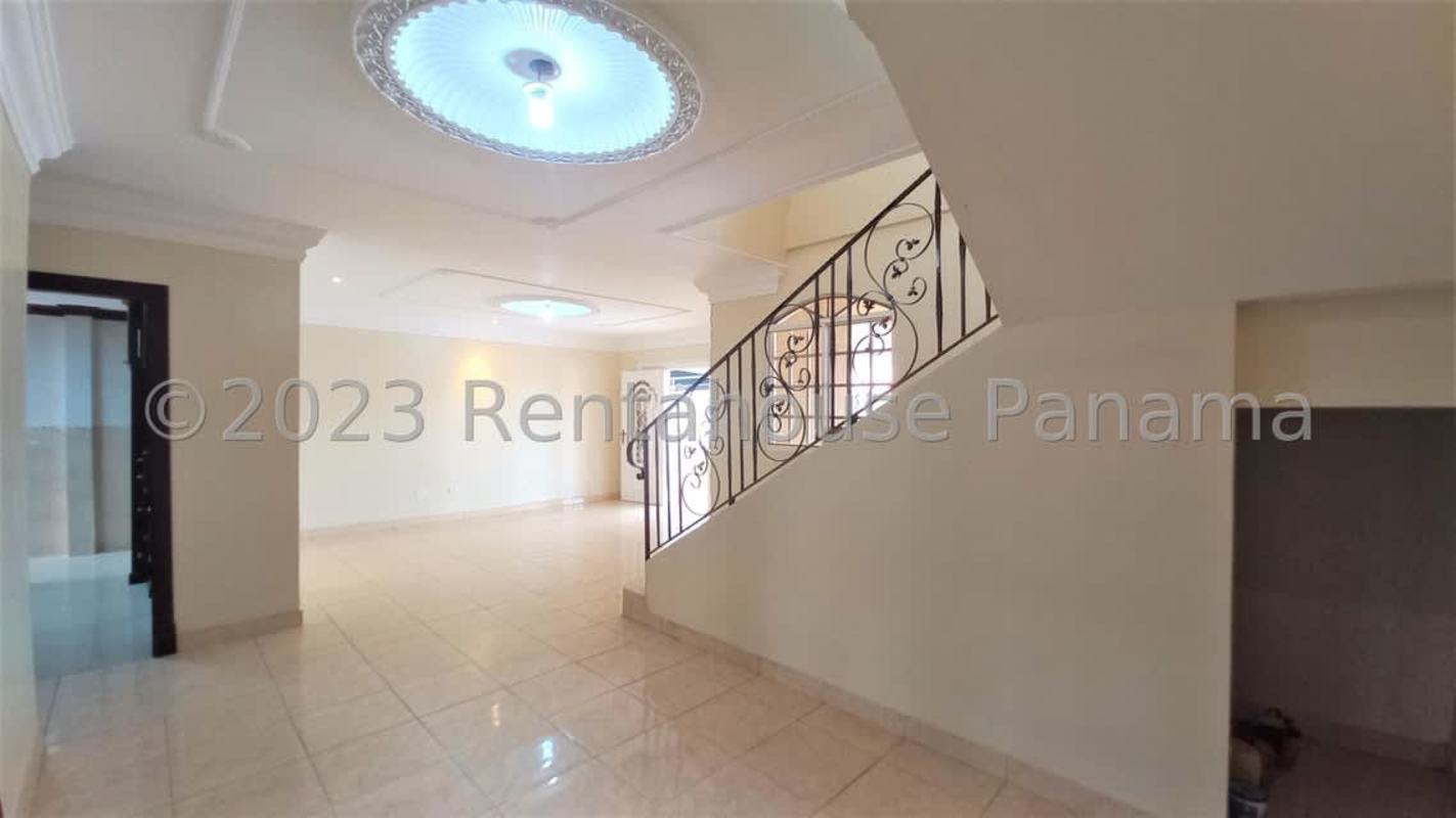 Traditional kitchen with granite countertop, island, wood cabinets and sliding door to patio in Panama City