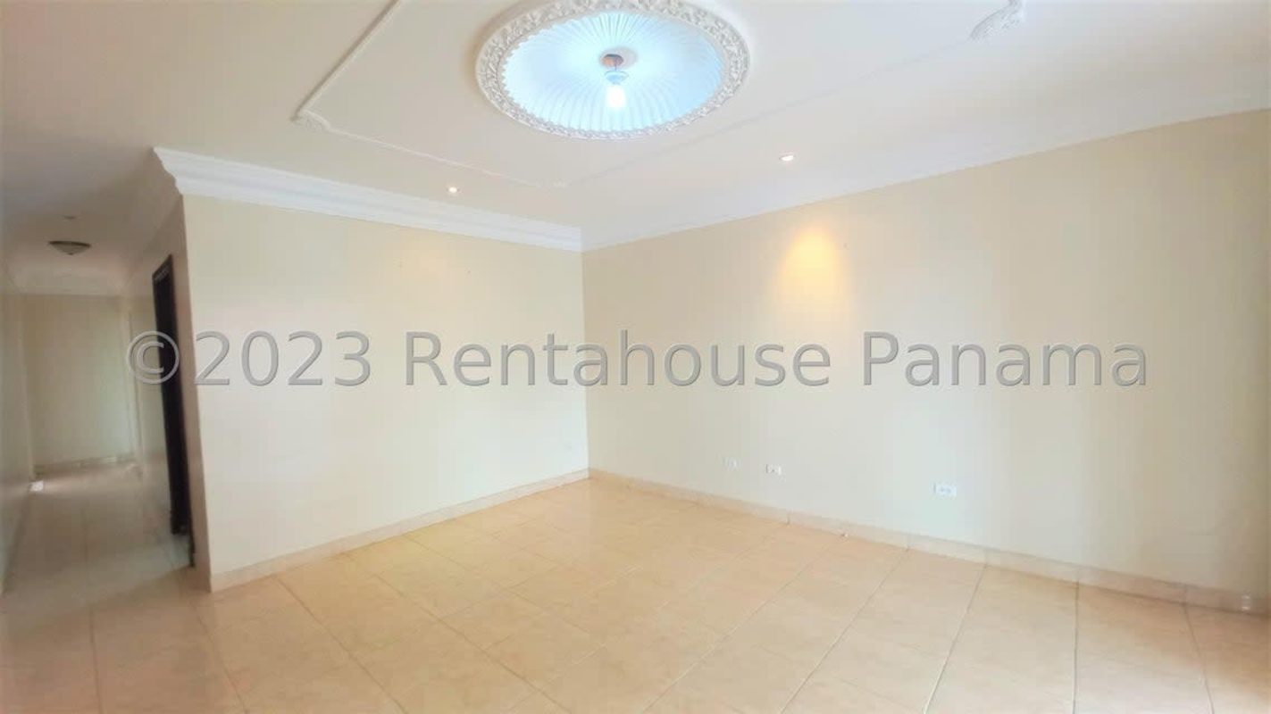 Spacious living room with tile flooring, crown molding and stair access in duplex home San Antonio Panama City