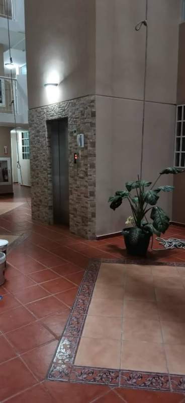 Modern lobby with elevator access stone accent wall potted plant in PH Llano Bonito Juan Diaz Panama City