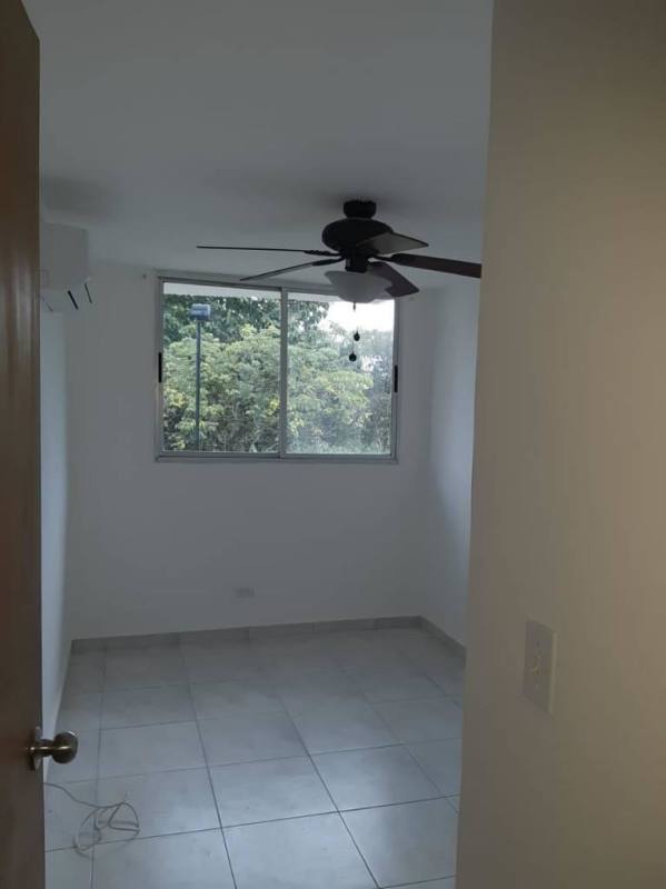 Empty bedroom with window, ceiling fan, tiled floors in PH Llano Bonito Panama City
