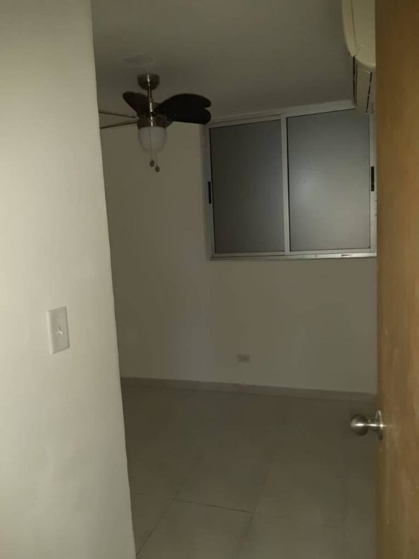 Empty clean bedroom white walls frosted window AC unit ceiling fan PH Llano Bonito Panama