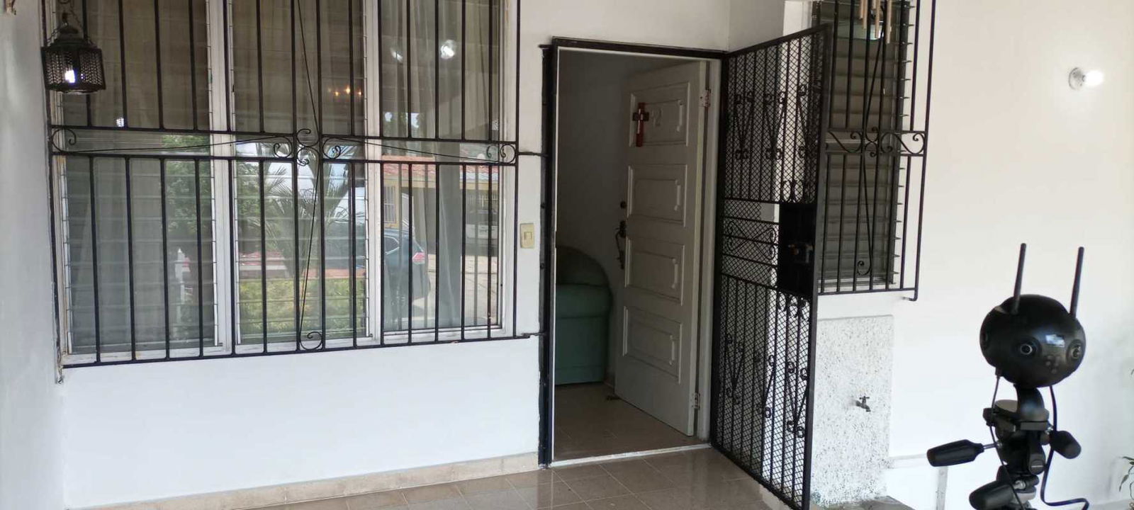 Entry porch with security bars windows and door in Las Cumbres Panama house for sale