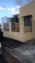 Side view of the house with driveway, security features, and fenced yard Costa Verde Panama