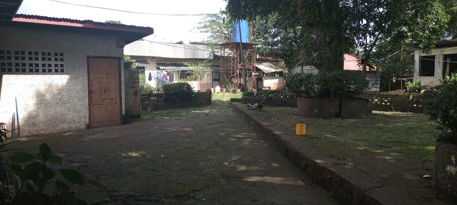 Courtyard with mature trees and rental units on investment land Pedregal Villalobos Panama