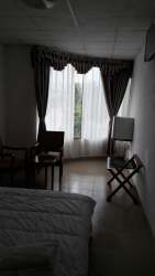 Bright hallway with tile flooring, multiple doors commercial hotel tower Paso Canoas.