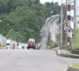 Curved border road, cars, sidewalks, utilities, Paso Canoas Panama Costa Rica border zone