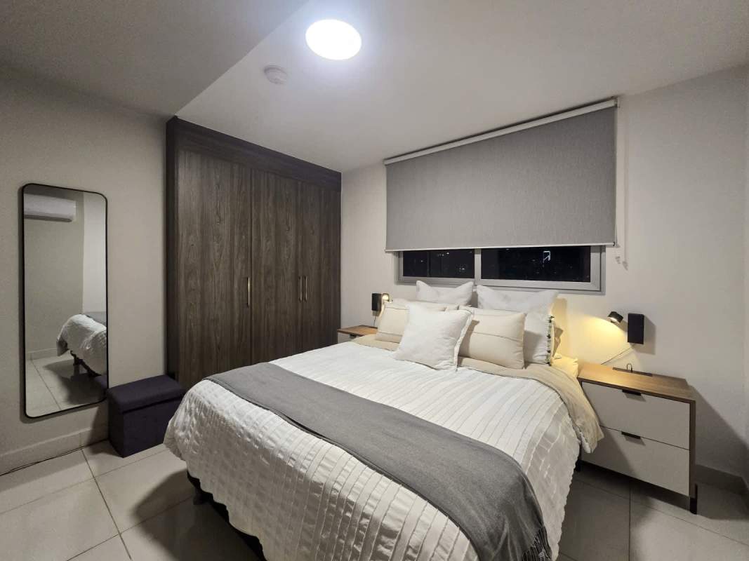 Bedroom with built-in closet and large window with city view PH Sky Point Carrasquilla Panama City