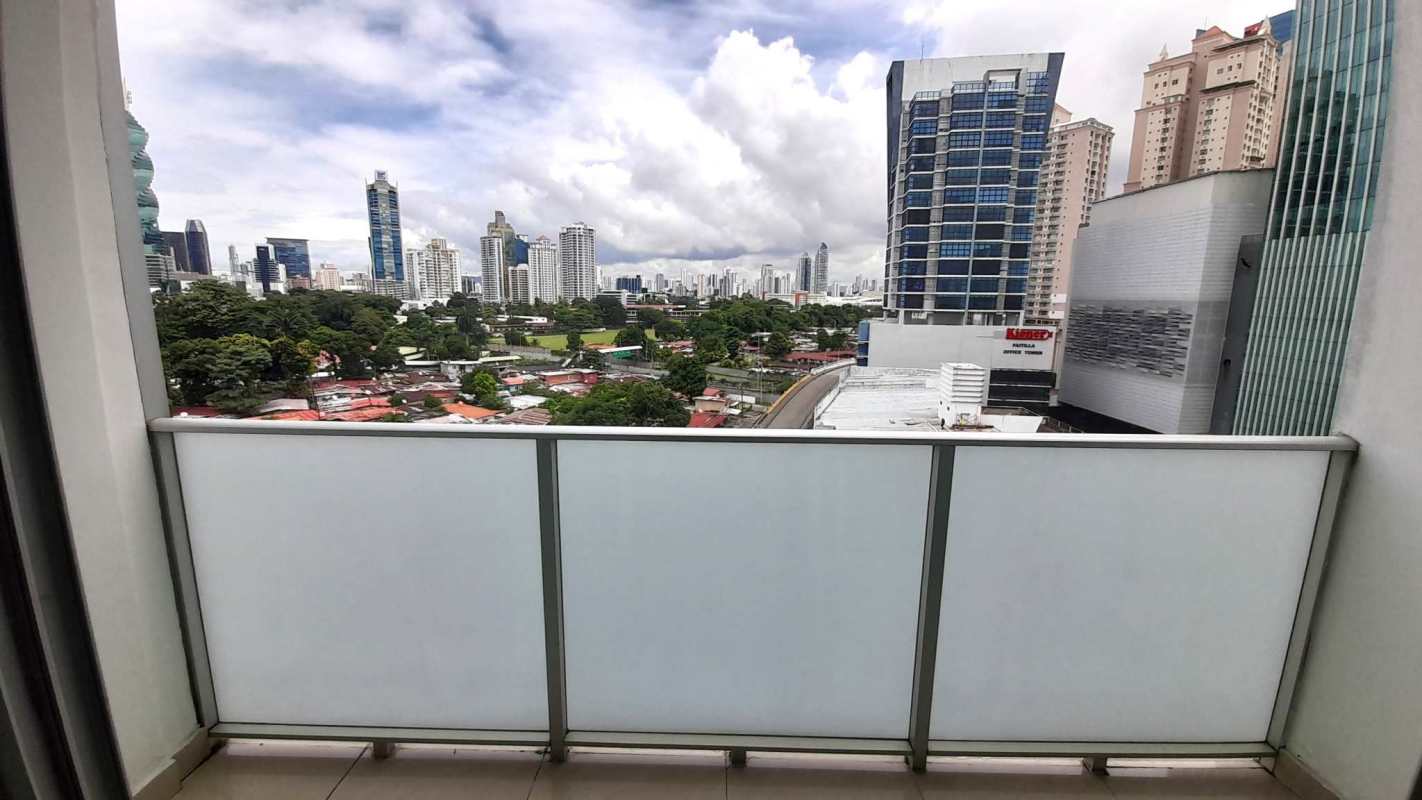 Apartment balcony with glass rail and city skyline view PH Pacific Sun Panama City