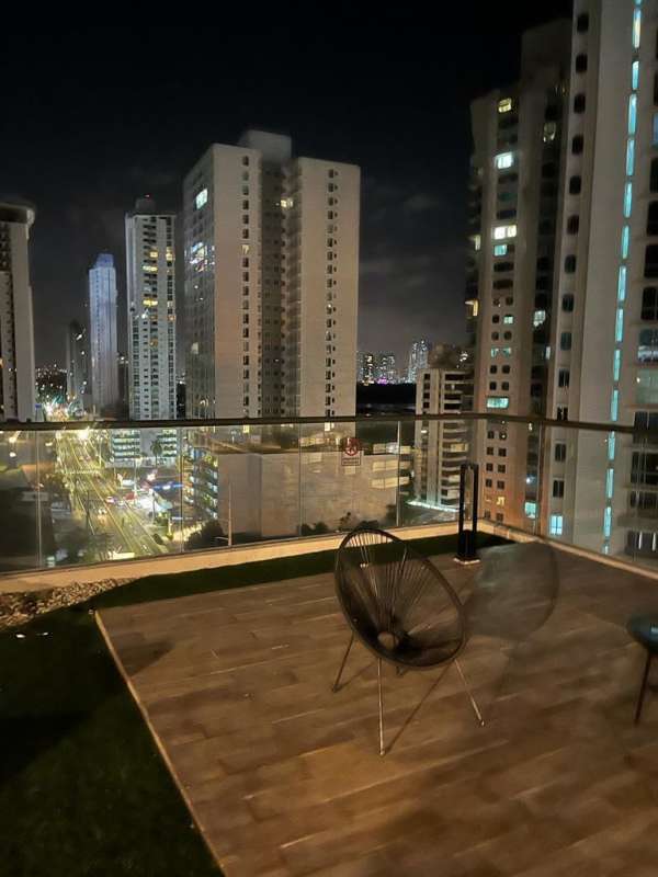 Modern rooftop pool illuminated at night with city skyline PH Coco del Mar Tower Panama City