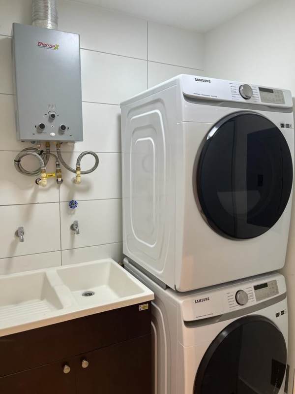 Laundry room with washer dryer and water heater in PH Coco del Mar Tower Panama