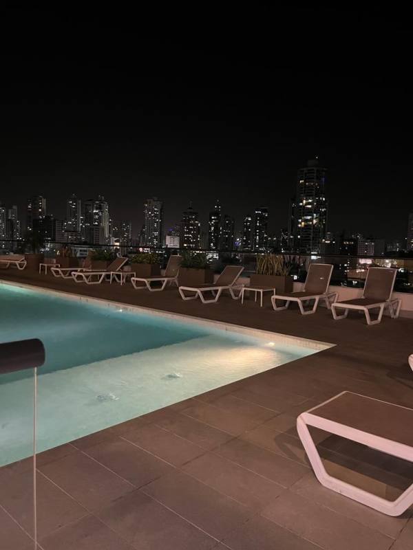 Balcony with night view, glass railing, city skyline at PH Coco del Mar Tower Panama City