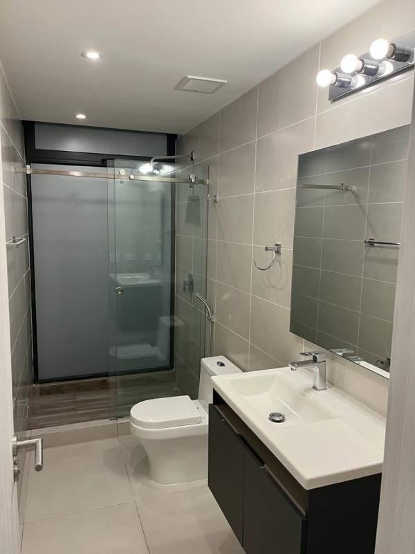 Modern bathroom with rain shower and sleek tile finish at PH Coco del Mar Tower Panama City