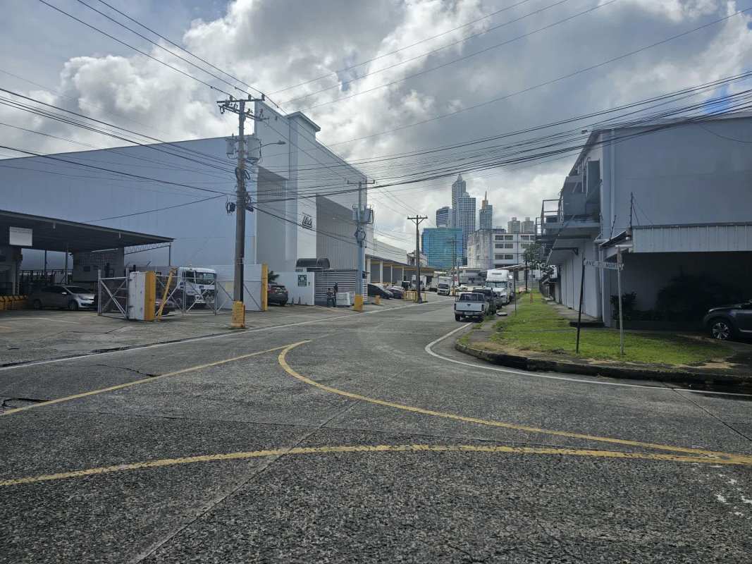 Entrance and inner roadways of industrial park with fenced lots and warehouses Panama City Pedregal