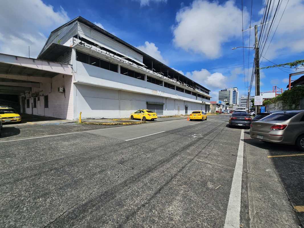 Street with warehouse buildings and trucks near industrial land in Los Angeles Pedregal Panama