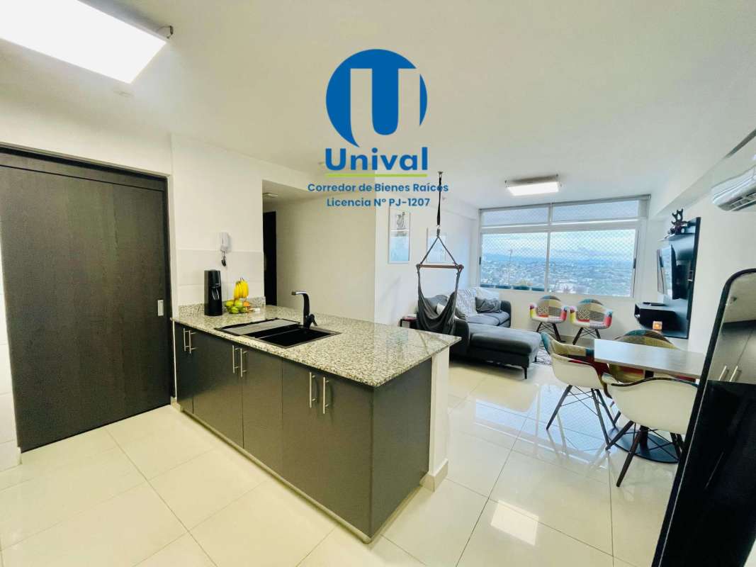 Renovated kitchen with granite countertops, bar seating, and appliances at PH Torres de Montserrat in Panama City