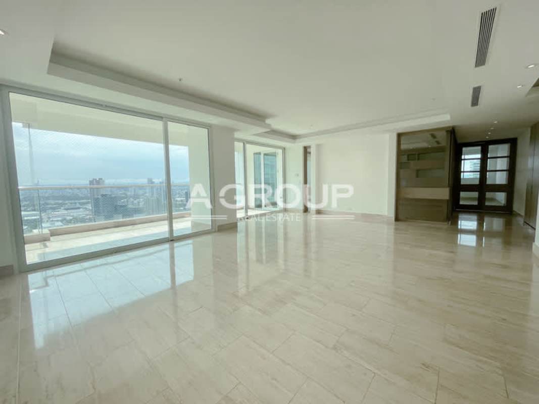 Large master bedroom with marble floors and ocean view window at PH Aria Costa del Este