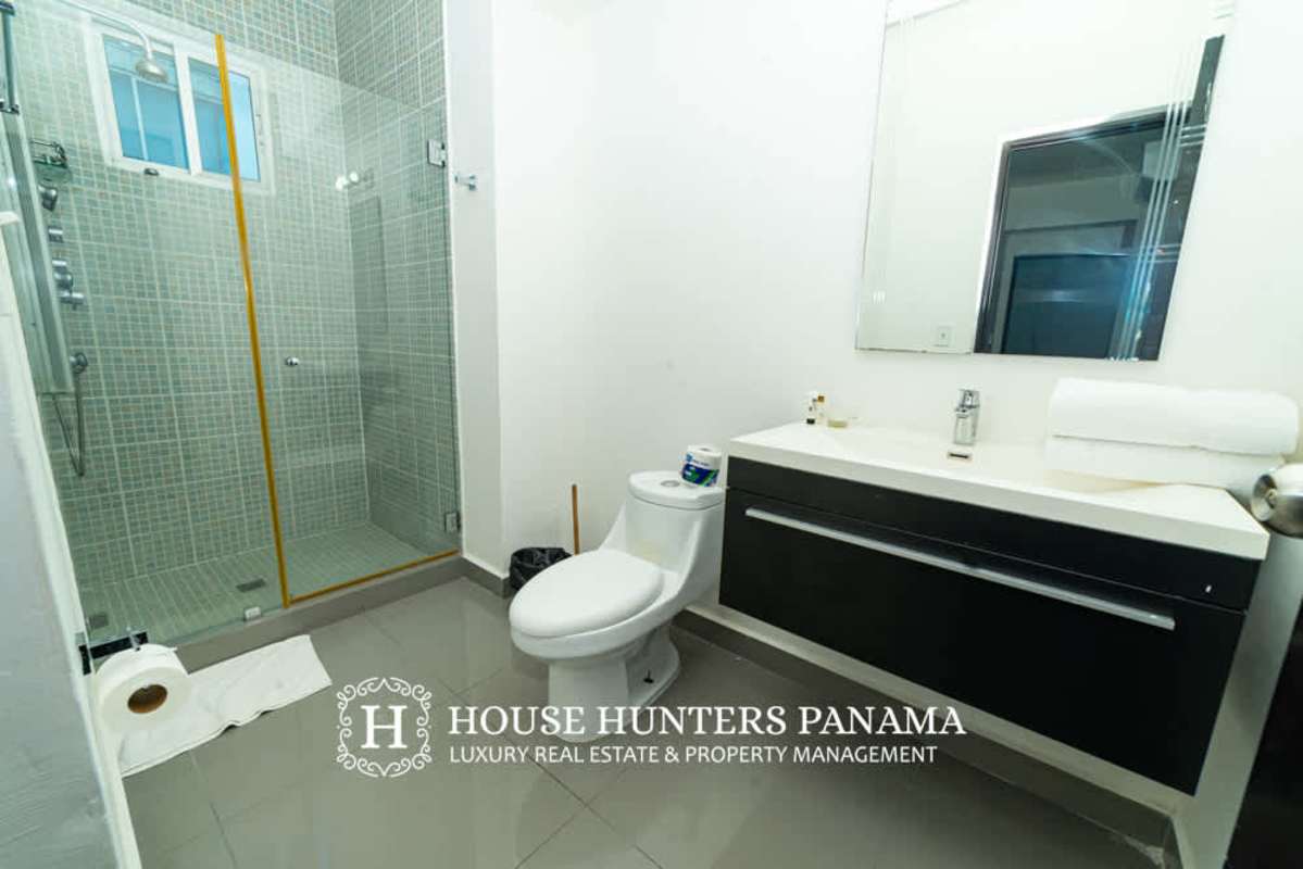 Contemporary bathroom design with glass-enclosed shower PH Quartier 74 Panama City