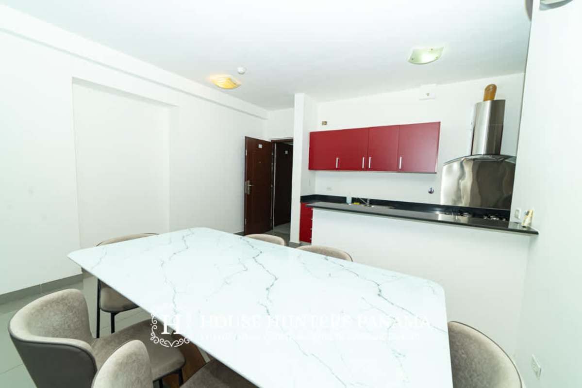 Modern gym with equipment, large windows city views at PH Quartier 74 San Francisco Panama