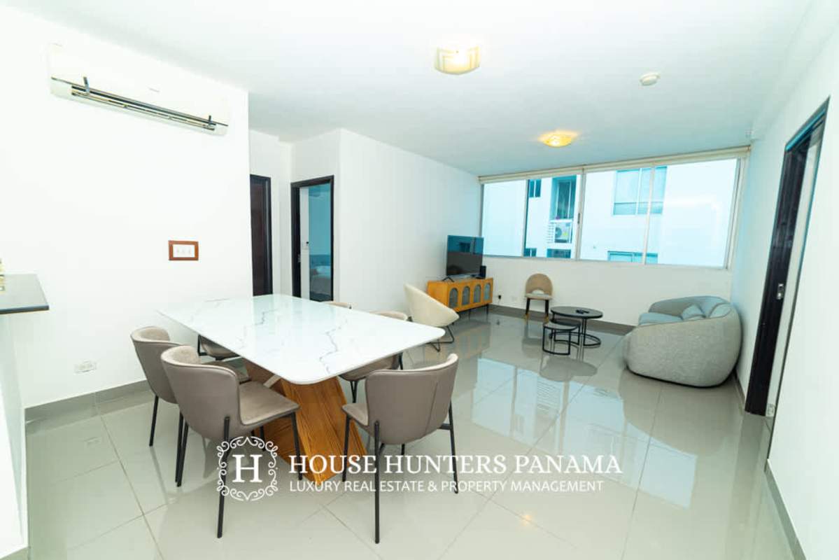 Bright living and dining room open plan with marble dining table, large windows at PH Quartier 74 San Francisco Panama