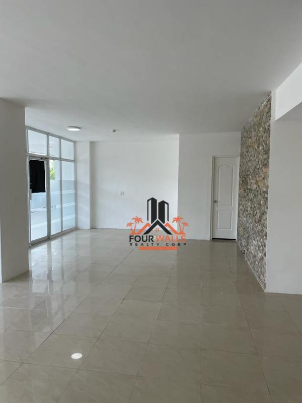 Empty retail or office premises with white tiled floor and feature wall Albrook Commercial Center Panama