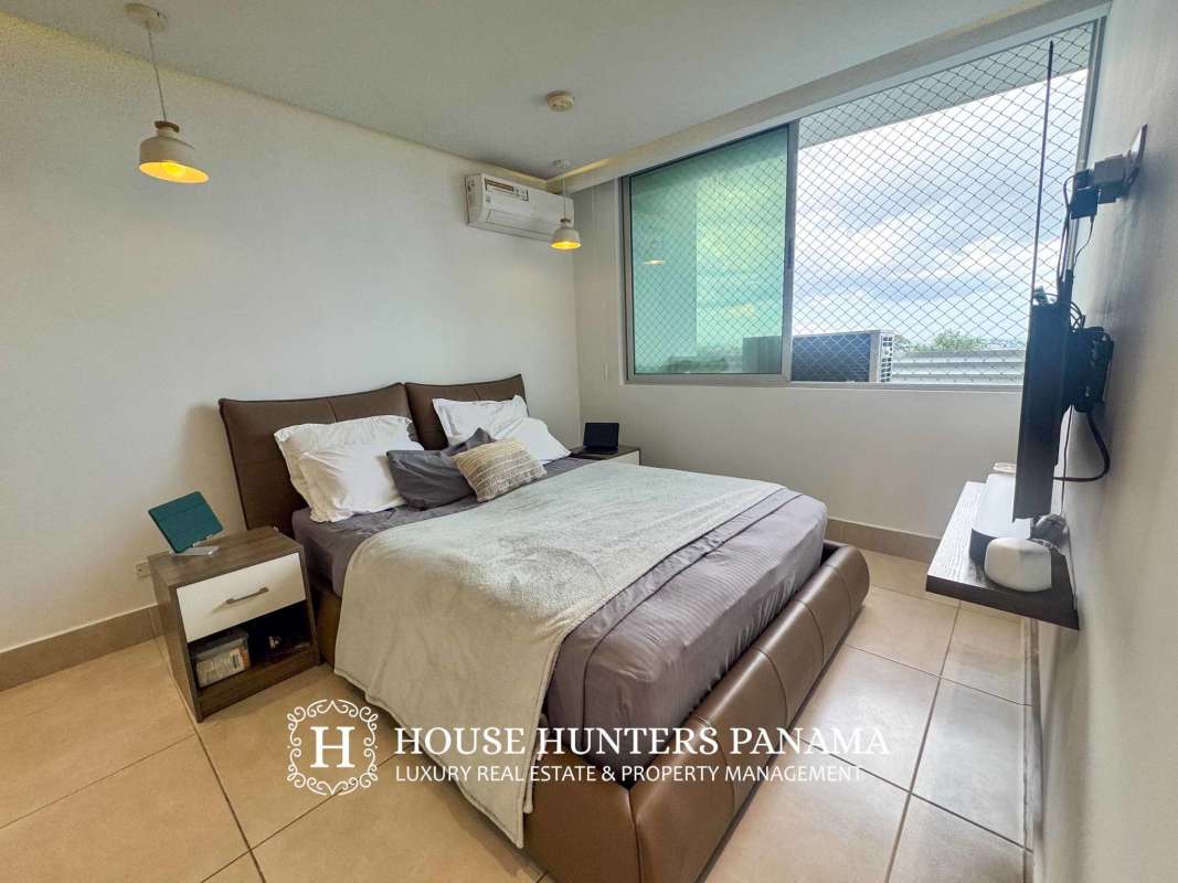 Modern living room with large sliding doors leading to balcony at PH Sky Point Towers Panama