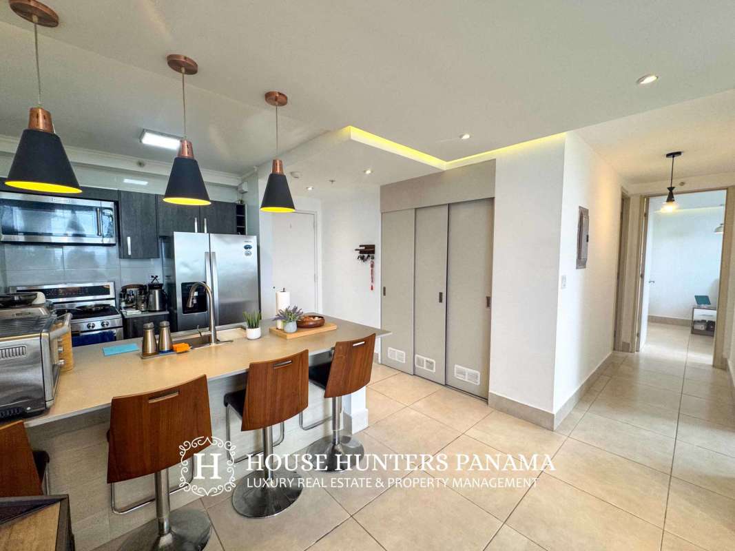 Bright master bedroom with large window at PH Sky Point Towers in Betania Panama City