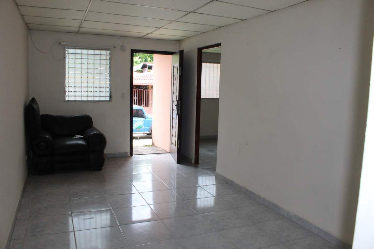 Simple bright living room with tiled floors and white walls Parque Real Panama City