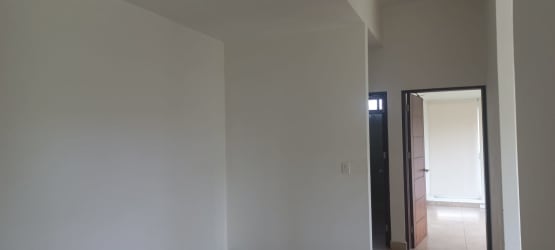 Bedroom with glass door leading to balcony overlooking garden PH Soleo Panama