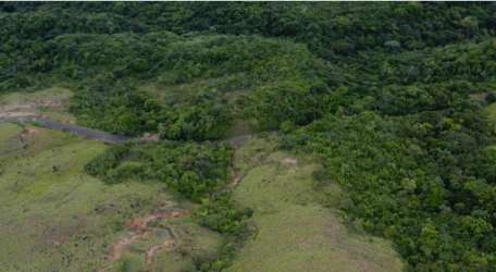 Aerial of mountain countryside paved access road forest and grasslands Panama