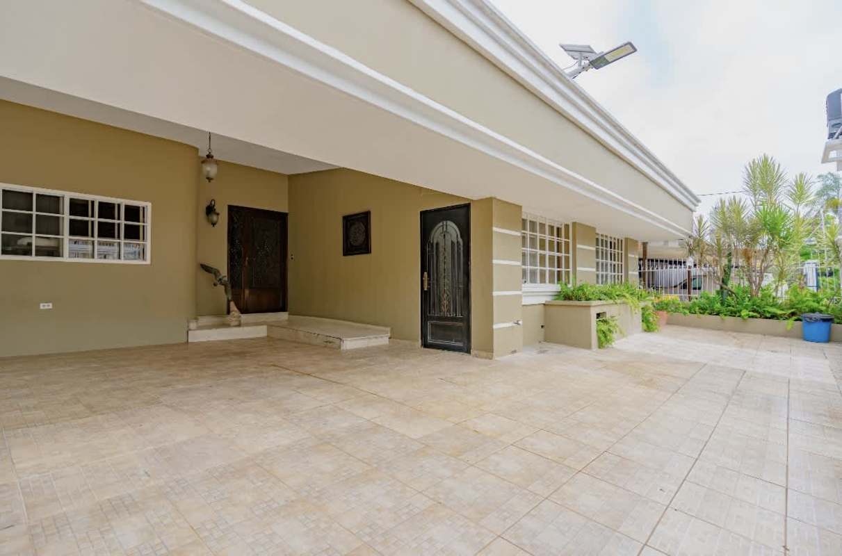 Modern kitchen with granite countertops, island, stainless steel appliances in La Loma Remodeled House Panama