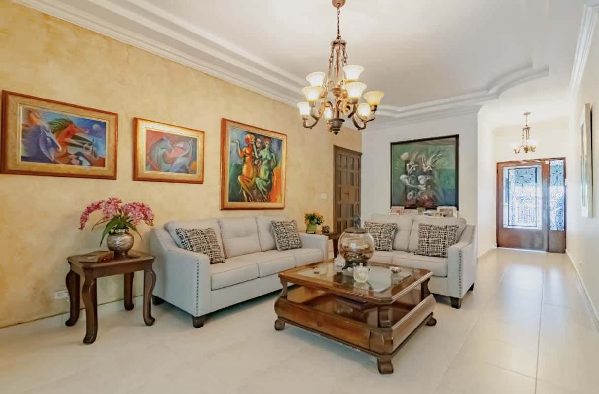 Open plan living and dining area with porcelain tile floor remodeled La Loma house Panama