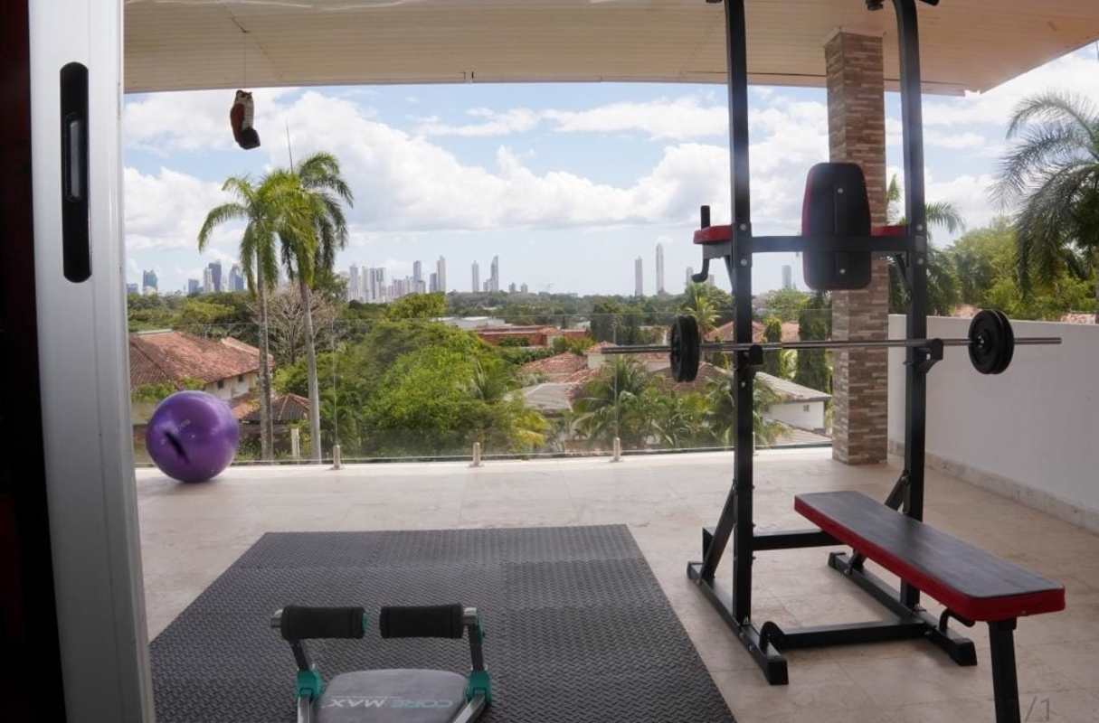 Fully equipped home gym with terrace and skyline views at Albrook luxury mansion Panama