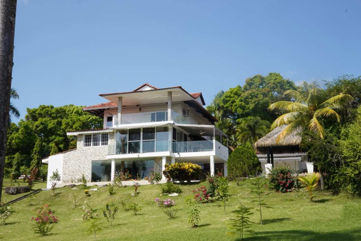 Three-story modern mansion with balconies, lush garden, gazebo and palm trees in Albrook Panama