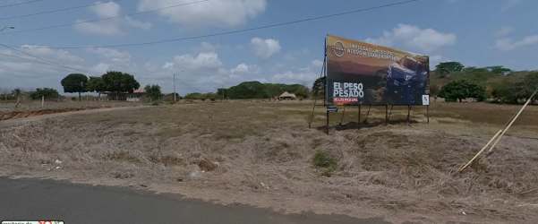 Open undeveloped flat land with roadside billboard at entrance of Las Tablas