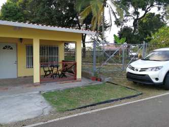 Backyard with tropical trees and garden space in Costa Baja Colon Panama home