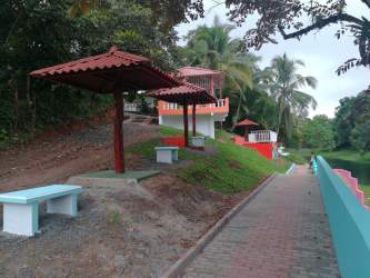 Landscaped outdoor recreation area with benches and tropical plants in Costa Baja Colon