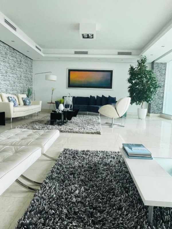 Contemporary living room with marble flooring and floor-to-ceiling ocean view windows PH Oceania Coast Panama
