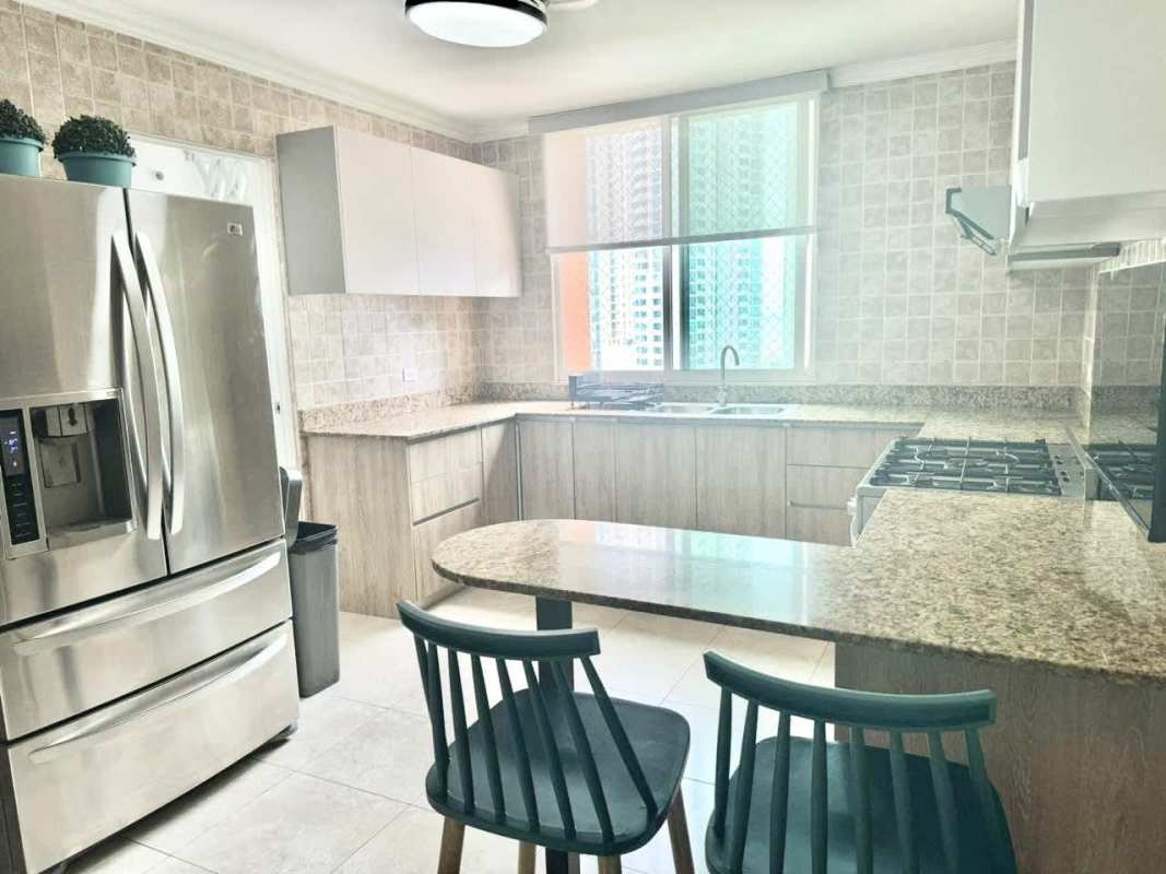 Minimalist living room with sectional sofa and colorful art in Pacific Point Panama apartment