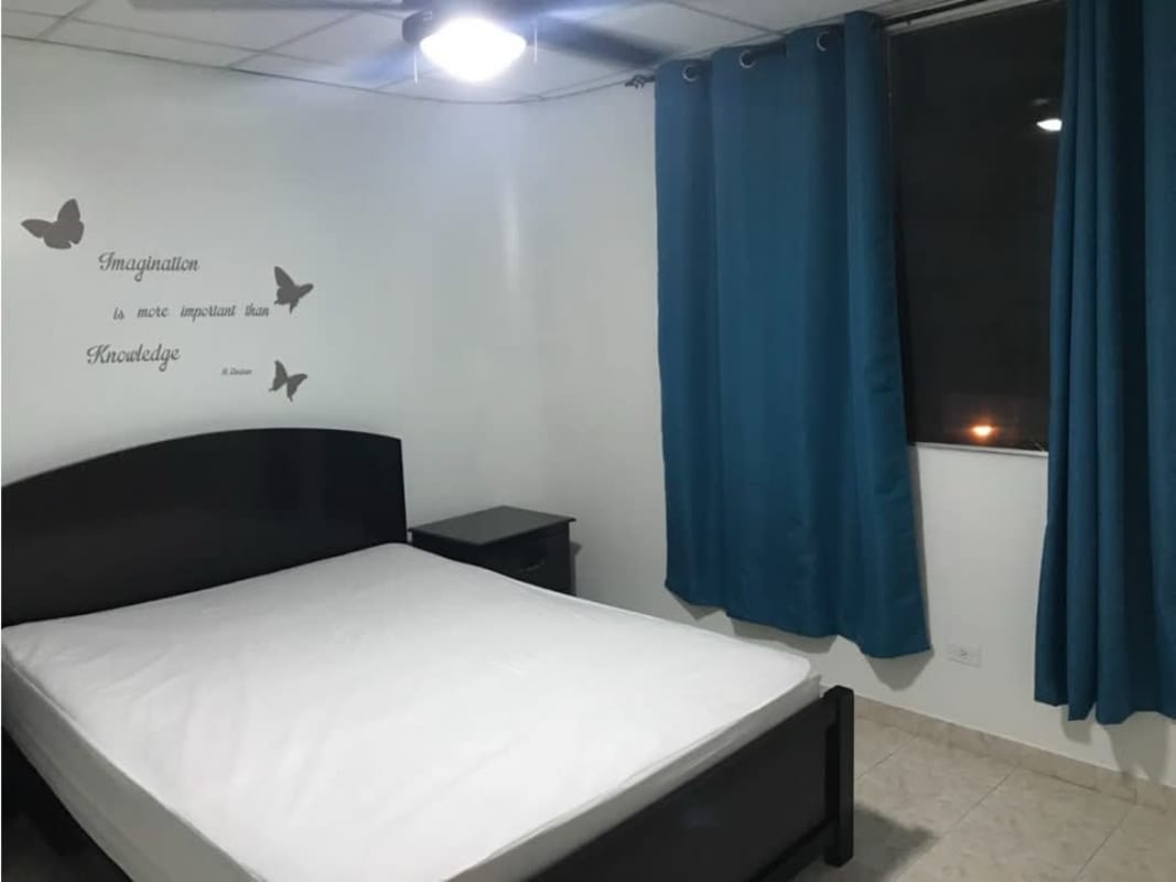 Simple bedroom with wall decals, ceiling fan, window Betania Panama apartment
