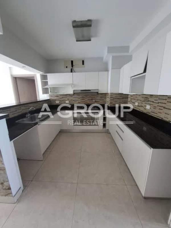 Modern kitchen with white cabinetry, granite counters in PH Harmony San Francisco