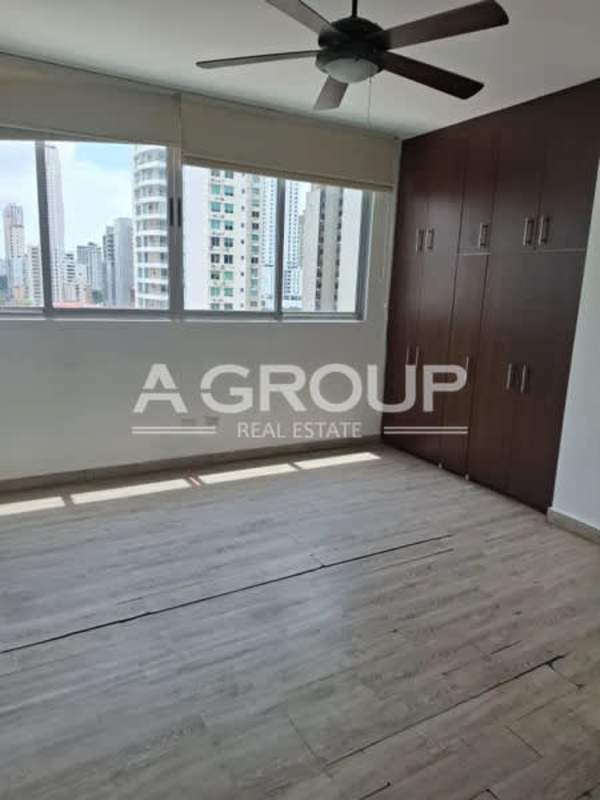 Modern bedroom with built-in closet, large windows in PH Harmony Panama