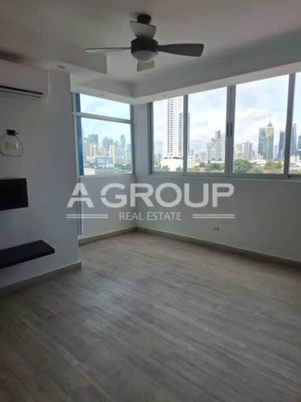 Modern building lobby with lounge seating and stone wall at PH Harmony San Francisco